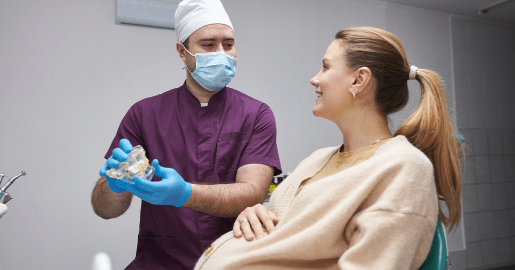 Pregnant woman talking with doctor.